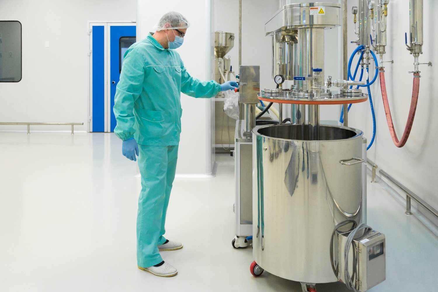 pharmaceutical-factory-man-worker-protective-clothing-working-with-control-panel-sterile-working-conditions (1)
